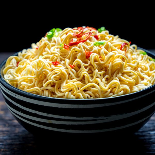 instant noodles in the bowl on wooden background